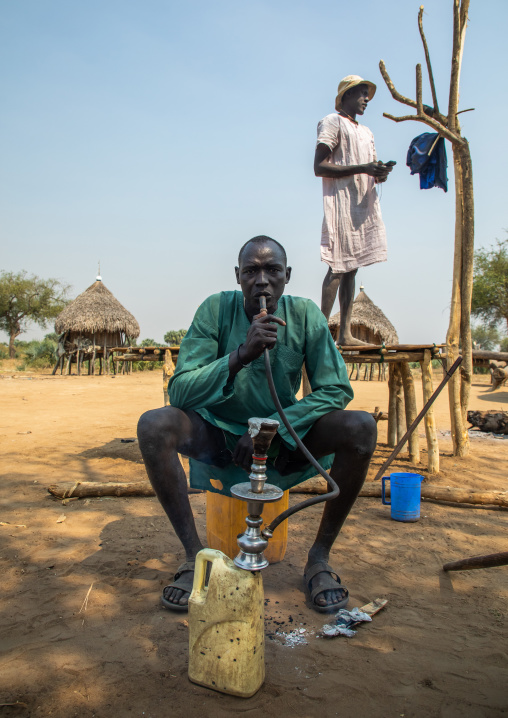 Mundari tribe man smoking shisha, Central Equatoria, Terekeka, South Sudan