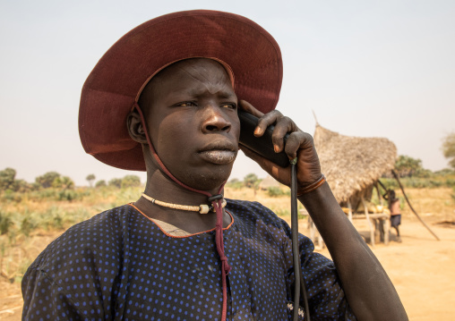 Mundari tribe man calling on his mobile phone, Central Equatoria, Terekeka, South Sudan