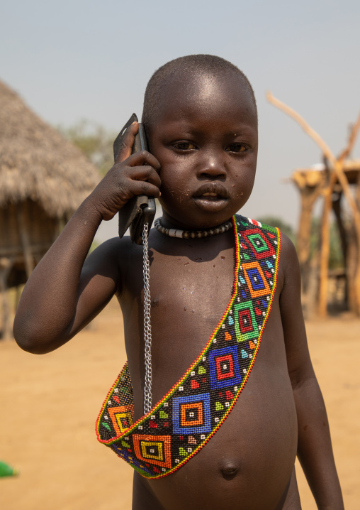 Mundari tribe boy using a mobile phone, Central Equatoria, Terekeka, South Sudan