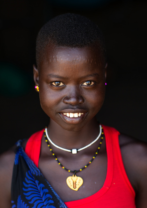 Portrait of a smiling Mundari young woman tribe, Central Equatoria, Terekeka, South Sudan