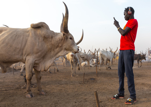 Mundari tribe student taking pictures in a cattle camp, Central Equatoria, Terekeka, South Sudan