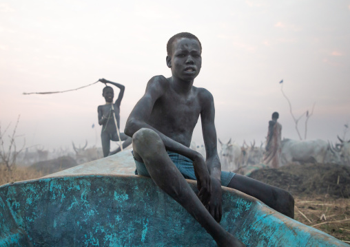 Mundari tribe boy sit on a boat, Central Equatoria, Terekeka, South Sudan