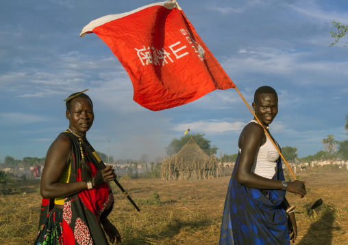 Mundari tribe women with a chinese flag celebrating a wedding, Central Equatoria, Terekeka, South Sudan