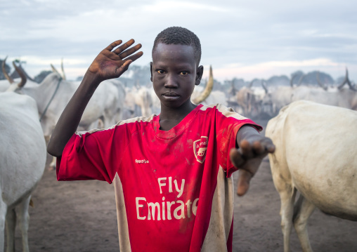 A Mundari tribe boy mimics the position of horns of his favourite cow, Central Equatoria, Terekeka, South Sudan
