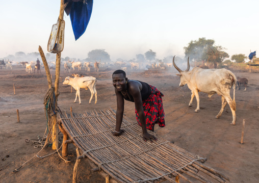 Mundari tribe woman near a bed in a long horns cows camp, Central Equatoria, Terekeka, South Sudan
