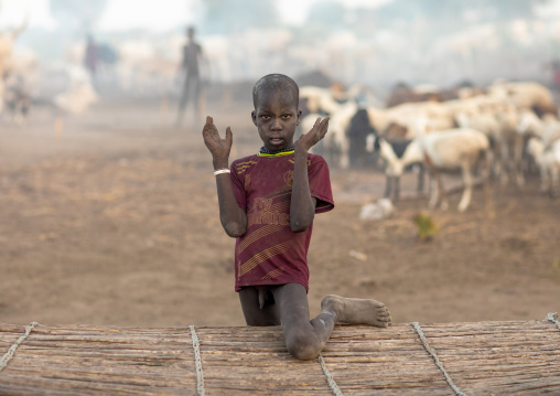 A Mundari tribe boy mimics the position of horns of his favourite cow, Central Equatoria, Terekeka, South Sudan