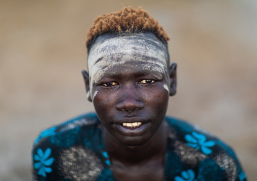 Mundari tribe boy covered in ash and hair dyed in orange with urine cow, Central Equatoria, Terekeka, South Sudan
