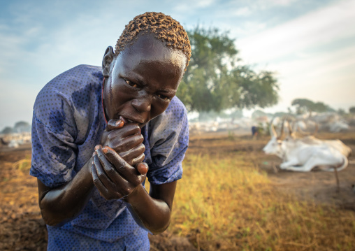 Mundari tribe boy showering with cow urine to take advantage of the antibacterial properties, Central Equatoria, Terekeka, South Sudan