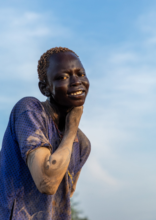 Mundari tribe man putting ash on his body after showering with cow urine, Central Equatoria, Terekeka, South Sudan