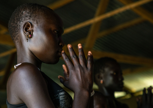 Mundari tribe girls praying during a sunday mass in a church, Central Equatoria, Terekeka, South Sudan