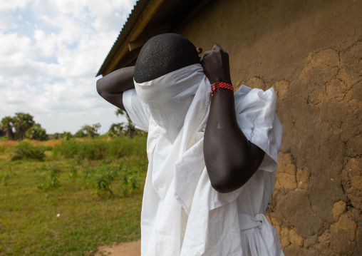 Mundari tribe nun putting her veil before a mass, Central Equatoria, Terekeka, South Sudan