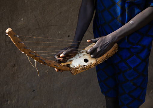 Mundari man playing local chordophone, Central Equatoria, Terekeka, South Sudan