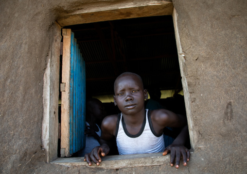 Mundari boy looking thru a window, Central Equatoria, Terekeka, South Sudan