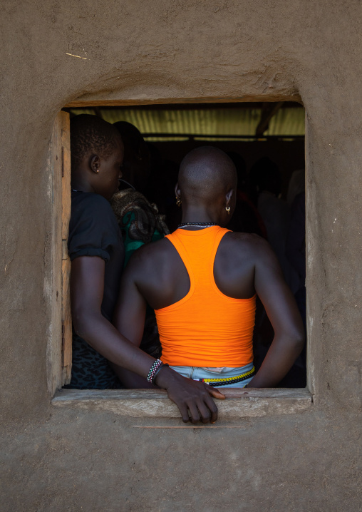 Mundari girls at a window of a house, Central Equatoria, Terekeka, South Sudan
