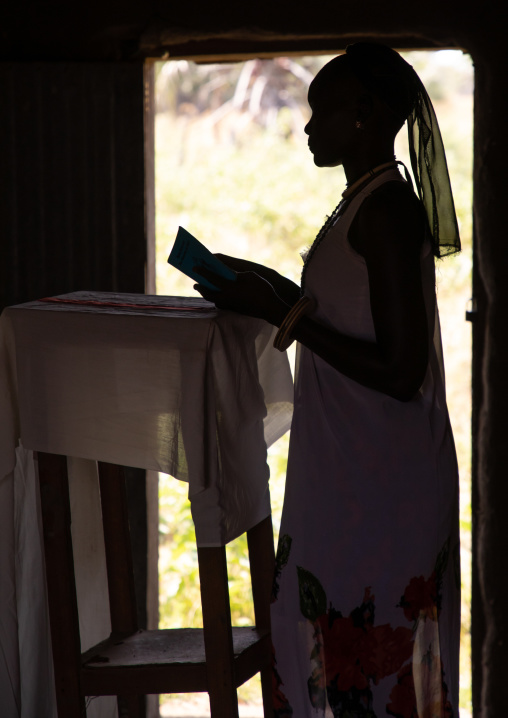 Mundari tribe nun reading the bible during a sunday mass in a church, Central Equatoria, Terekeka, South Sudan