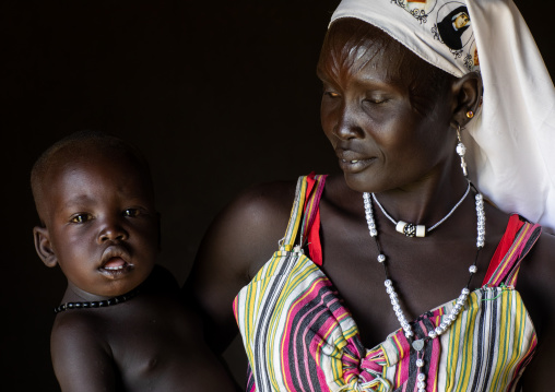 Portrait of a Mundari tribe nun with scarifications on the forehead with her child, Central Equatoria, Terekeka, South Sudan
