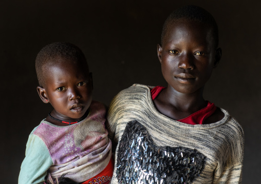 Portrait of a Mundari tribe boy with a child, Central Equatoria, Terekeka, South Sudan