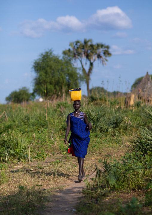 Mundari tribe woman carrying a yellow jerrican on the head, Central Equatoria, Terekeka, South Sudan