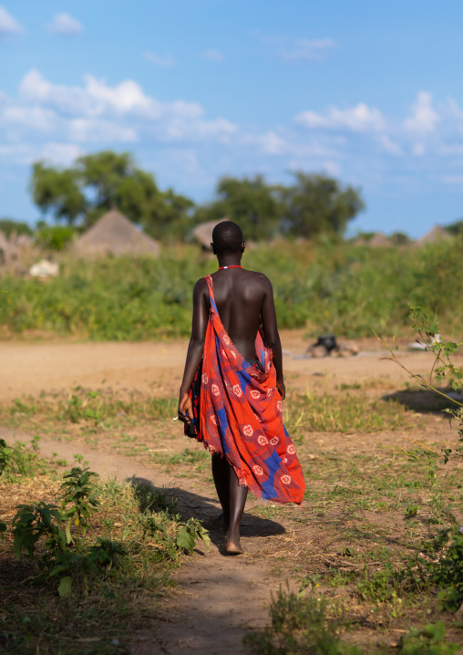 Mundari tribe woman walking in her village, Central Equatoria, Terekeka, South Sudan