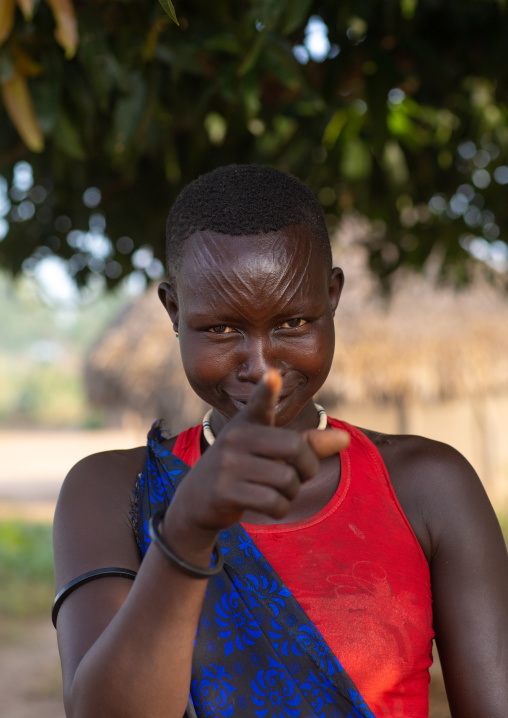 Mundari tribe woman pointing her finger to the photographer, Central Equatoria, Terekeka, South Sudan