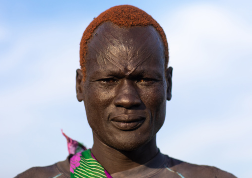 Portrait of a Mundari tribe man with scarifications on the forehead and hair dyed with cow urine, Central Equatoria, Terekeka, South Sudan