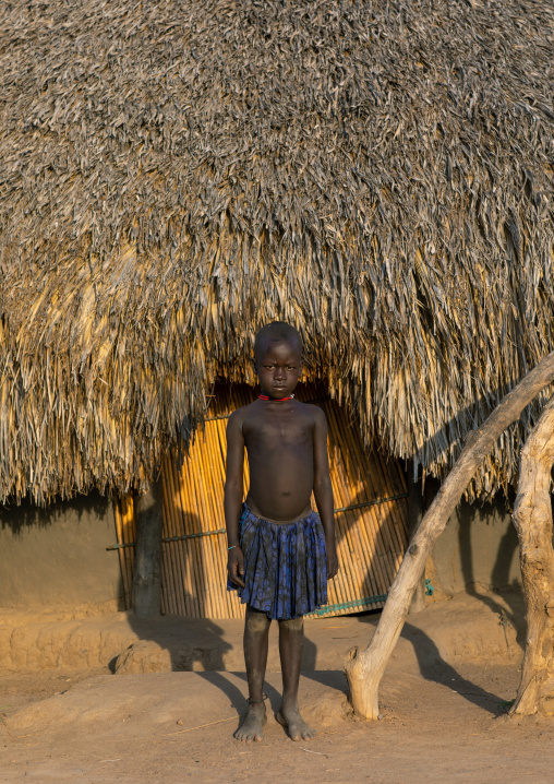 Mundari tribe child in front of a traditional house, Central Equatoria, Terekeka, South Sudan