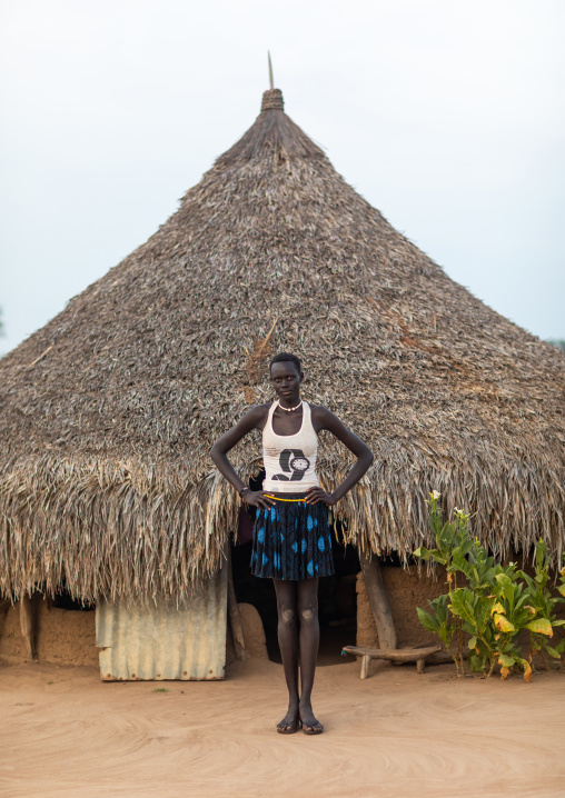 Mundari tribe woman standing in front of her traditional house, Central Equatoria, Terekeka, South Sudan