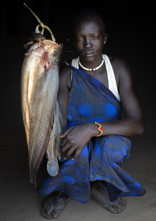 Portrait of a Mundari tribe woman with fresh fishes, Central Equatoria, Terekeka, South Sudan