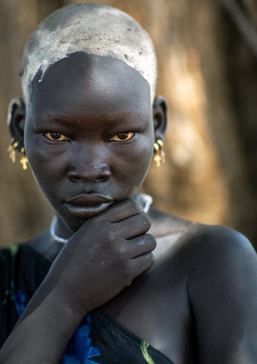 Portrait of a beautiful Mundari young woman with ash on the head to dye her hair in red, Central Equatoria, Terekeka, South Sudan