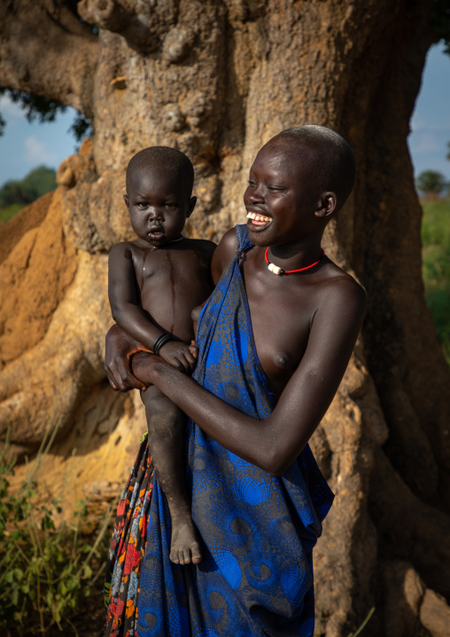 Portrait of a Mundari tribe young woman with a child, Central Equatoria, Terekeka, South Sudan