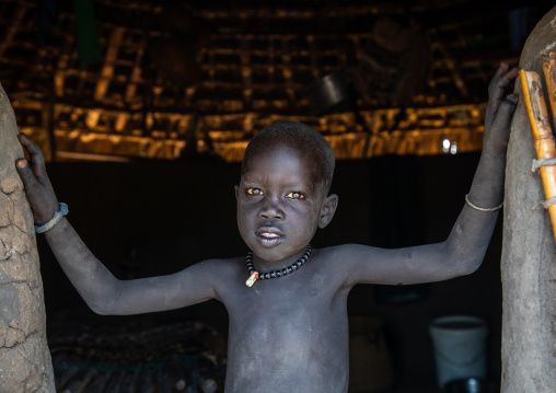 Portrait of a Mundari tribe boy at the entrance of his house, Central Equatoria, Terekeka, South Sudan