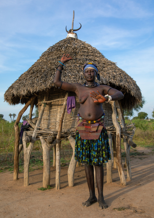 A Mundari tribe woman mimics the position of horns of his favourite cow, Central Equatoria, Terekeka, South Sudan