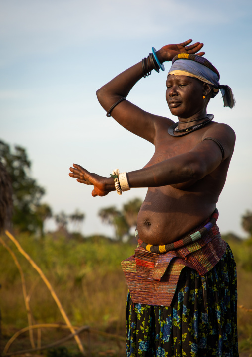 A Mundari tribe woman mimics the position of horns of his favourite cow, Central Equatoria, Terekeka, South Sudan