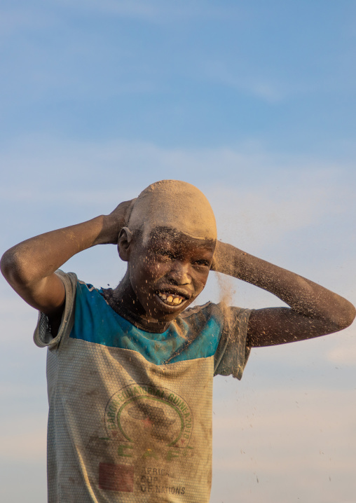 Mundari tribe boy covering his face in ash to protect from the mosquitoes and flies bites, Central Equatoria, Terekeka, South Sudan
