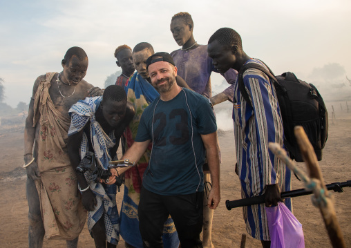 Tourist showing his pictures to Mundari tribe men, Central Equatoria, Terekeka, South Sudan
