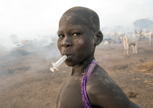 Portrait of a Mundari tribe boy with a syringe in the mouth, Central Equatoria, Terekeka, South Sudan