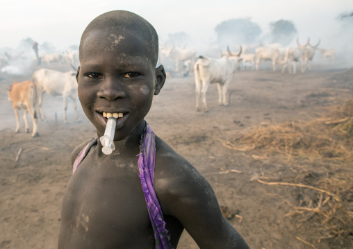 Portrait of a Mundari tribe boy with a syringe in the mouth, Central Equatoria, Terekeka, South Sudan