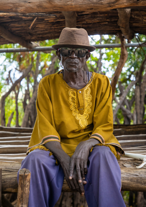 Old Lotuko tribe man wearing sunglasses and a hat, Central Equatoria, Illeu, South Sudan