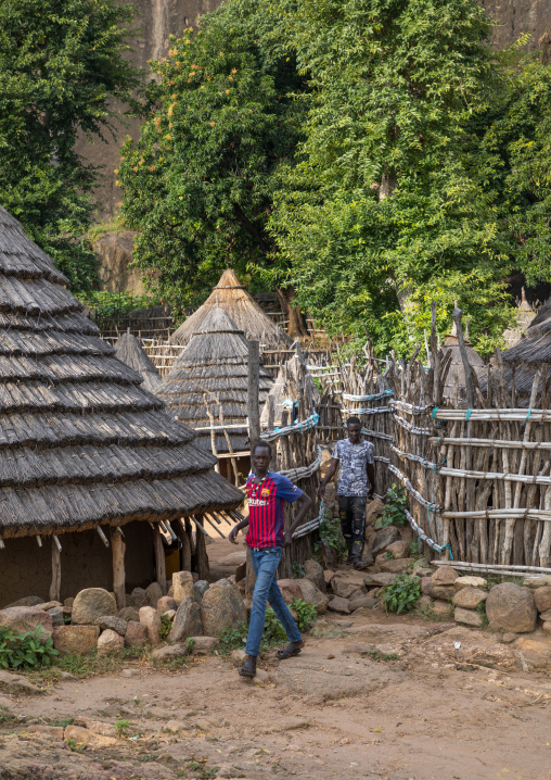 Young men in front of a Lotuko tribe thatched house, Central Equatoria, Illeu, South Sudan