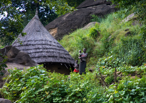 Family in front of a Lotuko tribe thatched house, Central Equatoria, Illeu, South Sudan