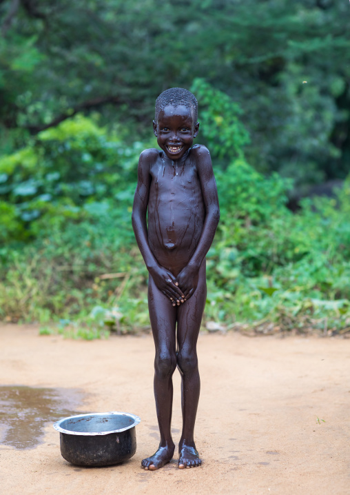 Portrait of a Larim tribe boy taking his bath, Boya Mountains, Imatong, South Sudan
