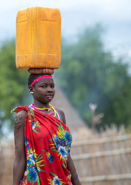 Portrait of a Larim tribe woman carrying a yellow jerrican on the head, Boya Mountains, Imatong, South Sudan