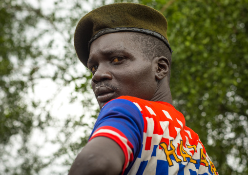 Portrait of a former soldier from Larim tribe wearing a chelsea football shirt, Boya Mountains, Imatong, South Sudan