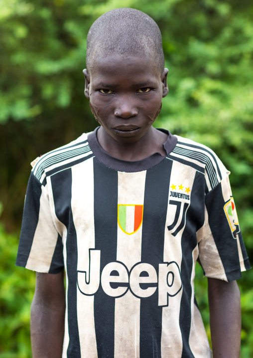 Larim tribe boy waering a juventus football shirt and with scarifications on the cheek, Boya Mountains, Imatong, South Sudan