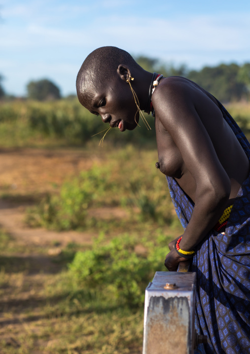 Mundari tribe woman pumping water in a well, Central Equatoria, Terekeka, South Sudan