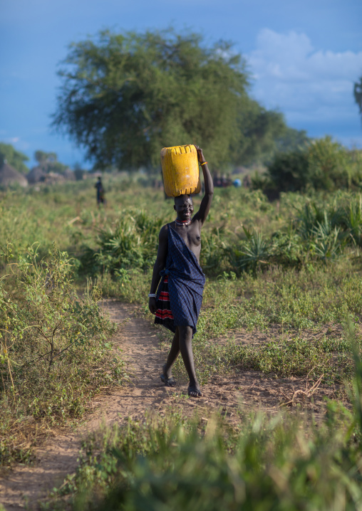 Mundari woman carrying a jerrican of water on her head, Central Equatoria, Terekeka, South Sudan