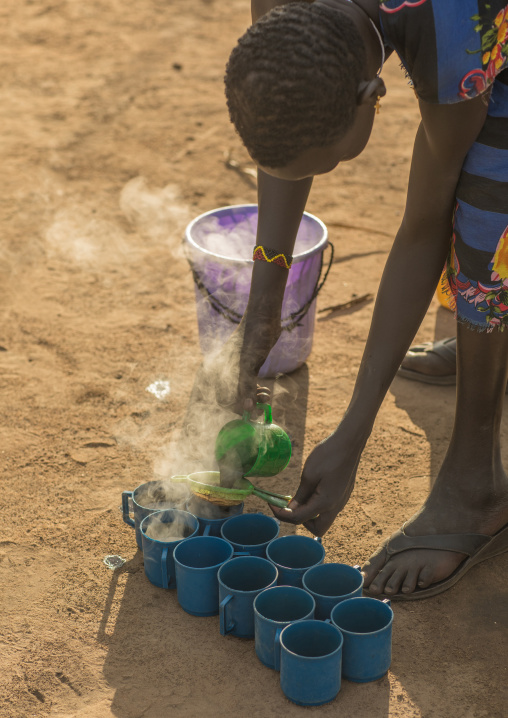 Mundari woman preparing coffee in the morning, Central Equatoria, Terekeka, South Sudan