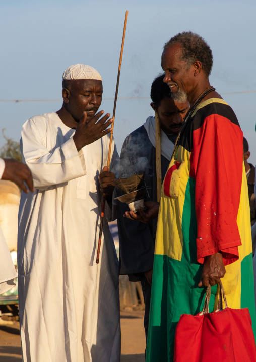 Man with insence during the friday sufi celebration at sheikh Hamad el Nil tomb, Khartoum State, Omdurman, Sudan