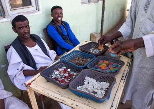 Sudanese cashiers selling buttons which will be used as money in a coffee shop, Khartoum State, Khartoum, Sudan