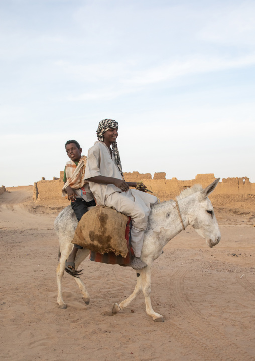 Sudanese men riding a donkey, Northern State, Al-Khandaq, Sudan